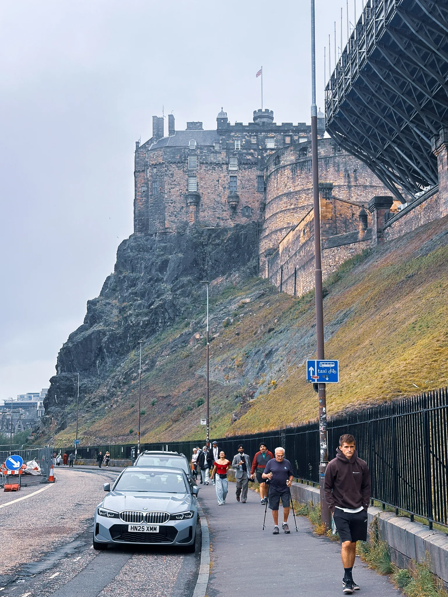 The castle from Johnston Terrace below, the Tattoo's scaffolded stands hanging off the esplanade edge and walkers strung along the railings