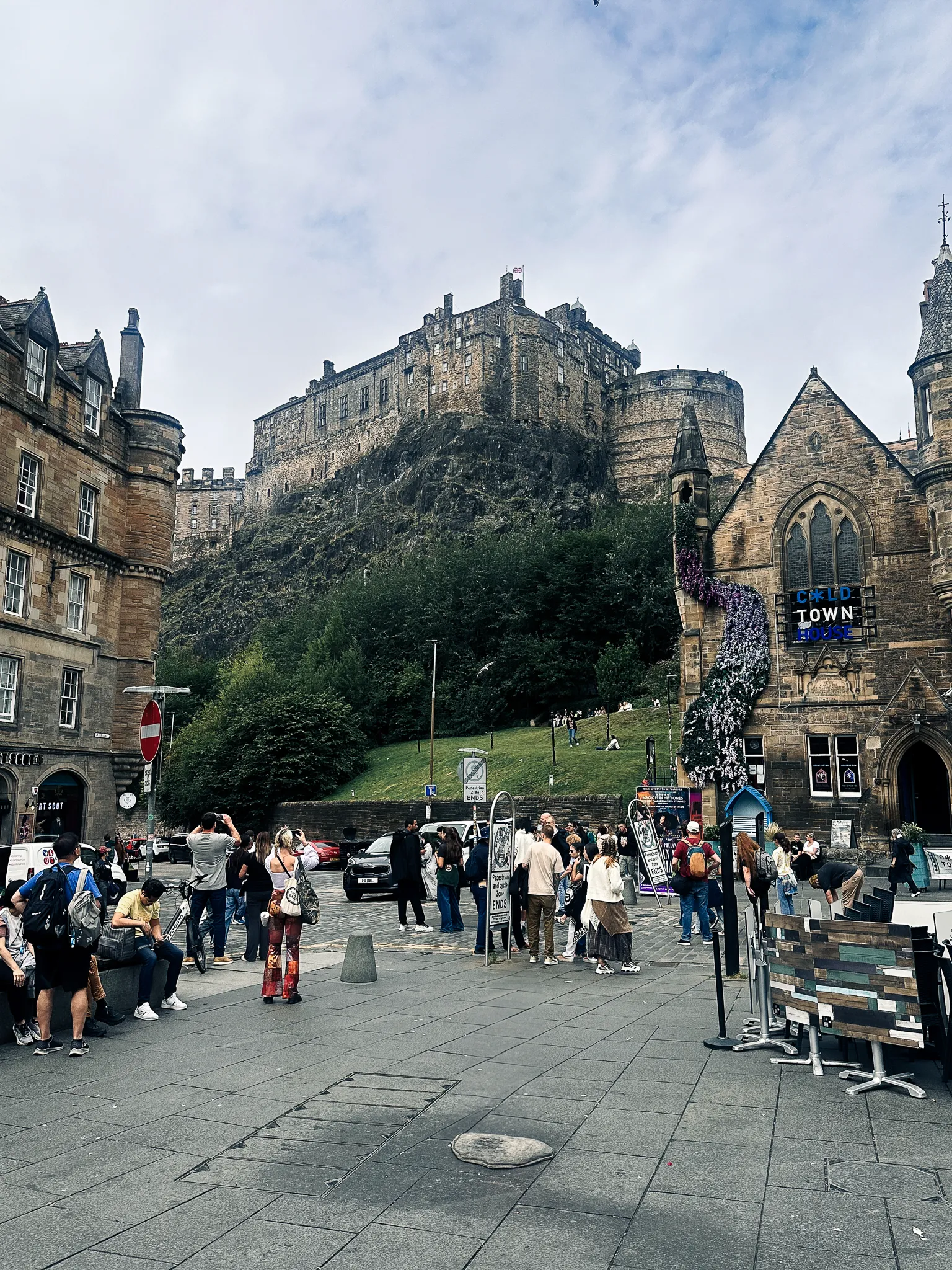 The cloud finally lifting off the castle above the Grassmarket, wisteria down Cold Town House and half the square taking the same photograph
