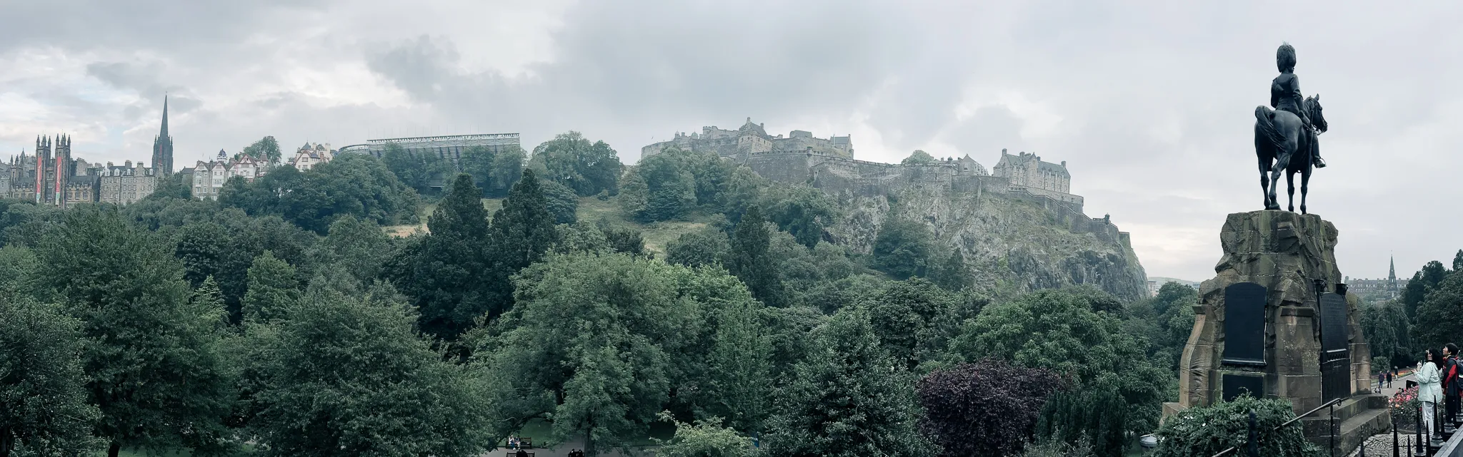 The whole length of the rock in one frame from Princes Street - the Hub's spire to the ramparts, the Royal Scots Greys horseman dark on the right