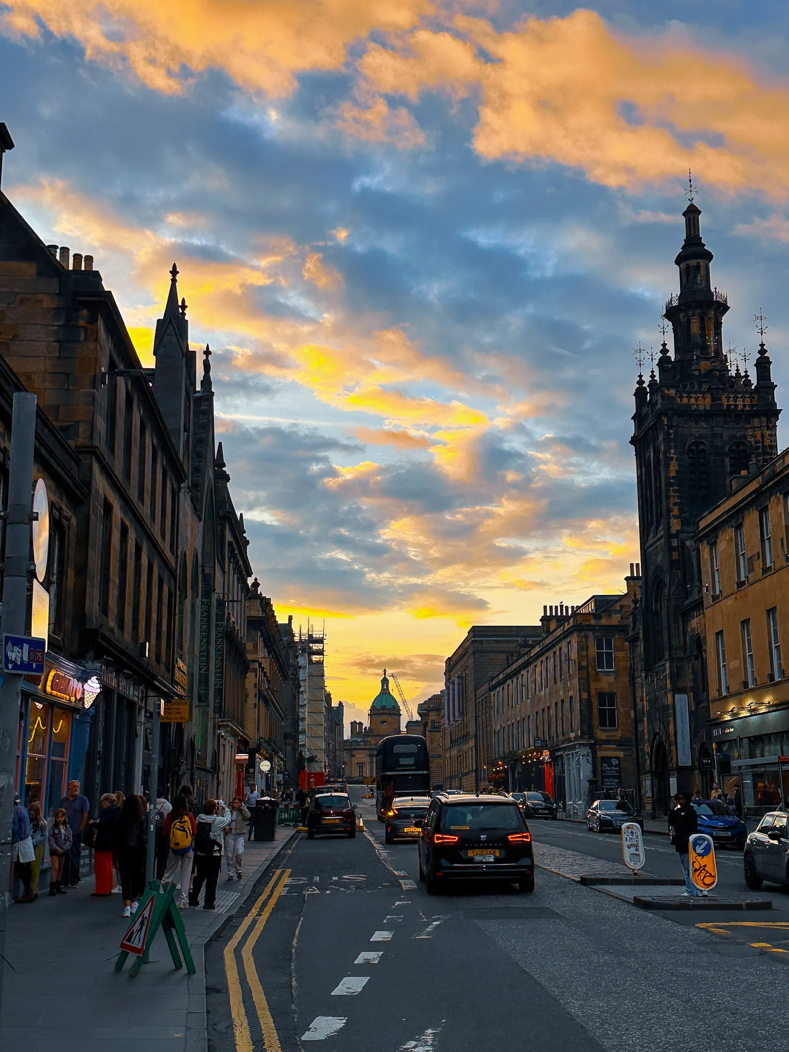 The sky going orange over George IV Bridge, the Bank of Scotland's dome small at the end of the street and a church tower black against the clouds