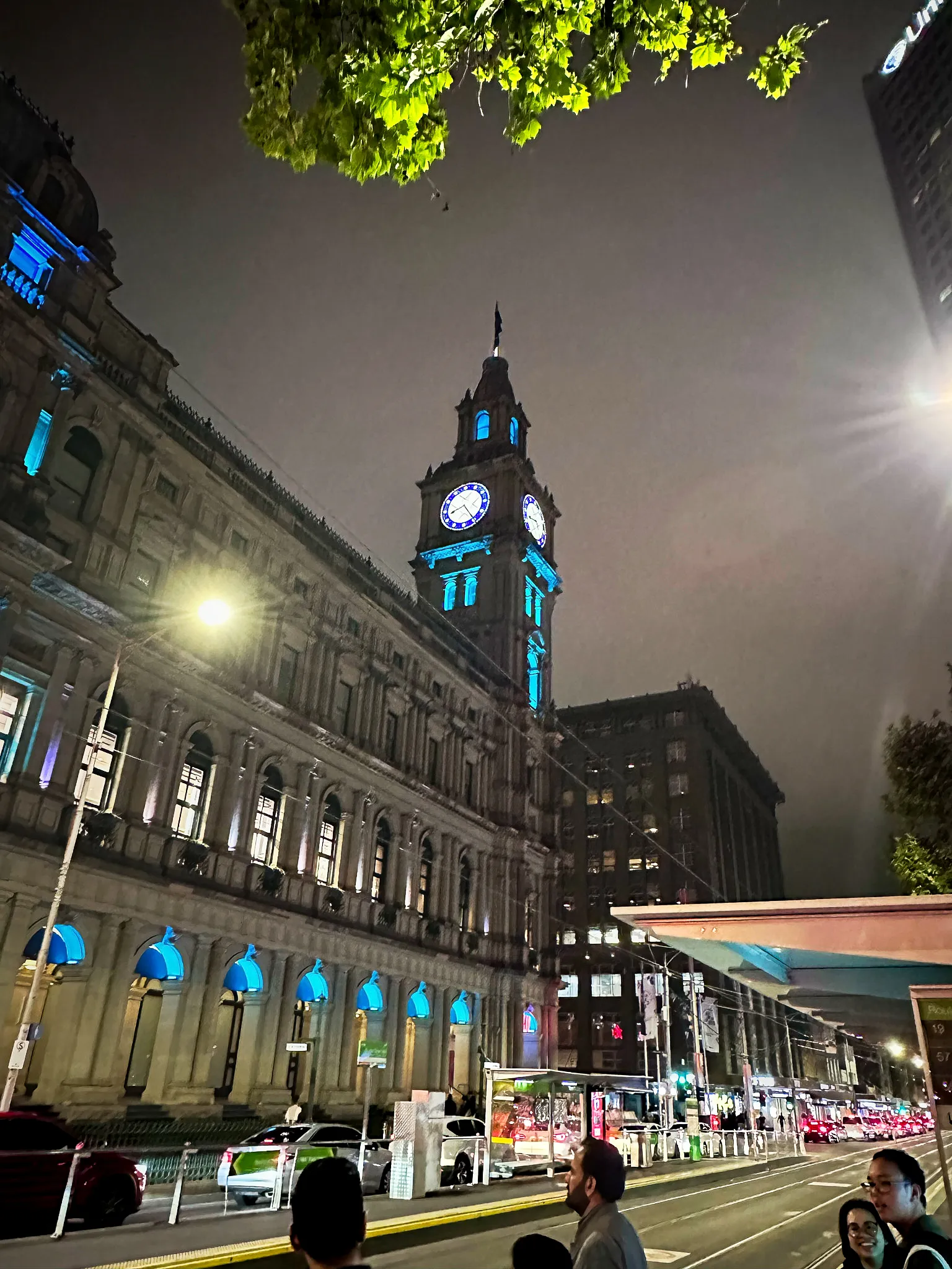 Melbourne's General Post Office lit blue at night, its clock tower against a dark sky